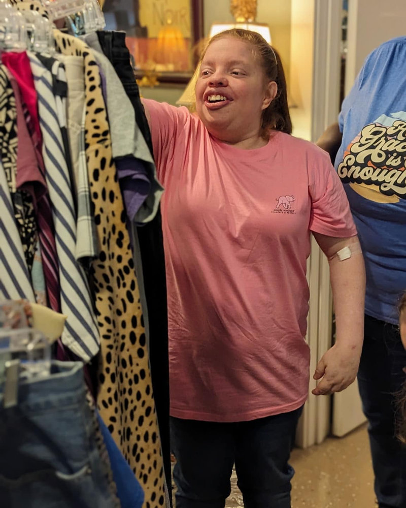 A COI participant smiling during a community outing